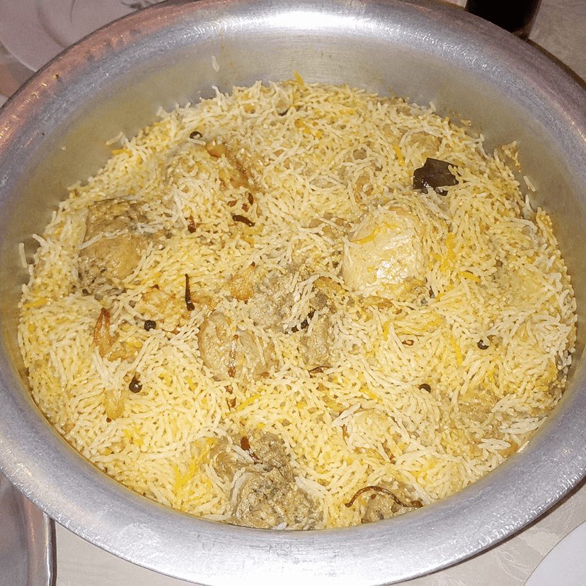 Chicken biryani photographed with a harsh flash and washed-out color.